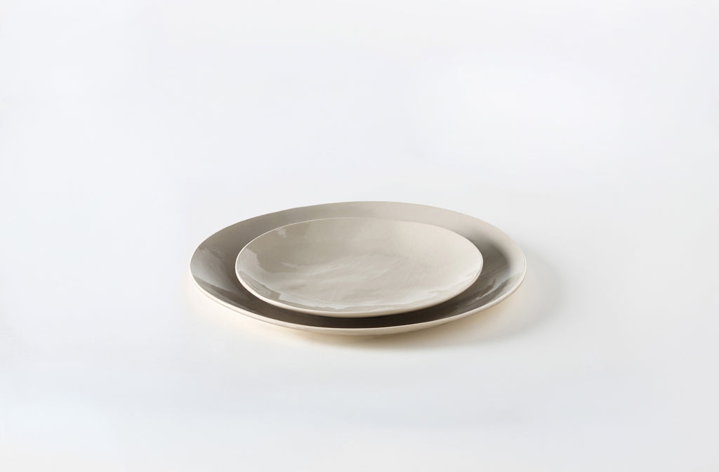 Two Brickett Davda taupe plates stacked on a white background. Default