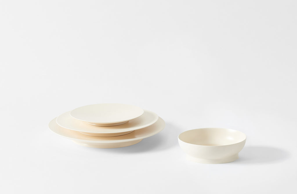 Ann Demeulemeester white ceramic dinnerware set on a light gray background. Default