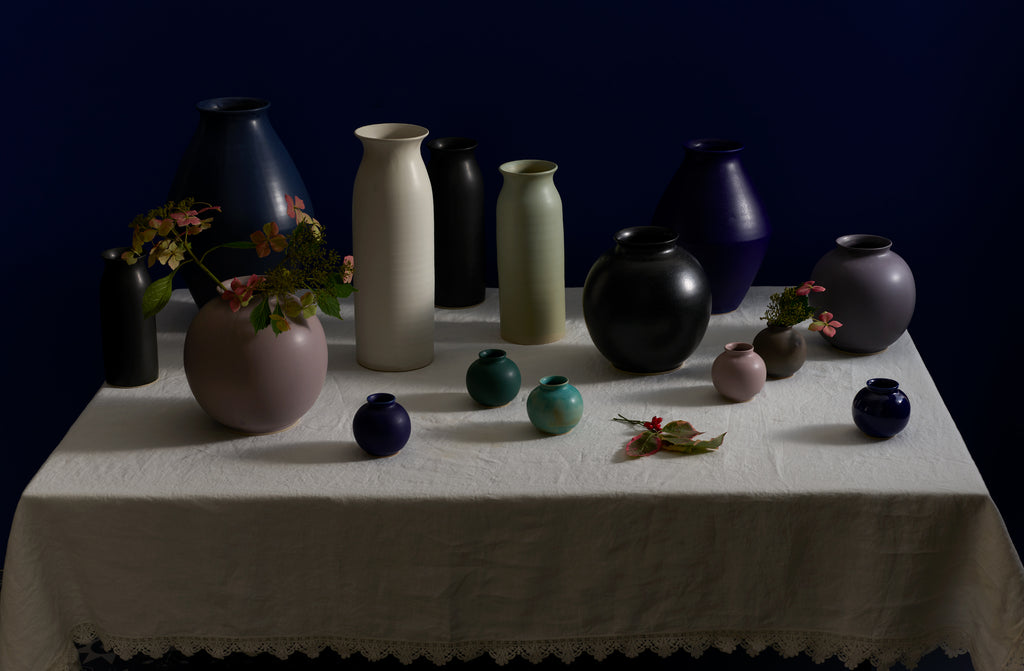 Mixture of Christiane Perrochon vases set on off white Sicily table cloth