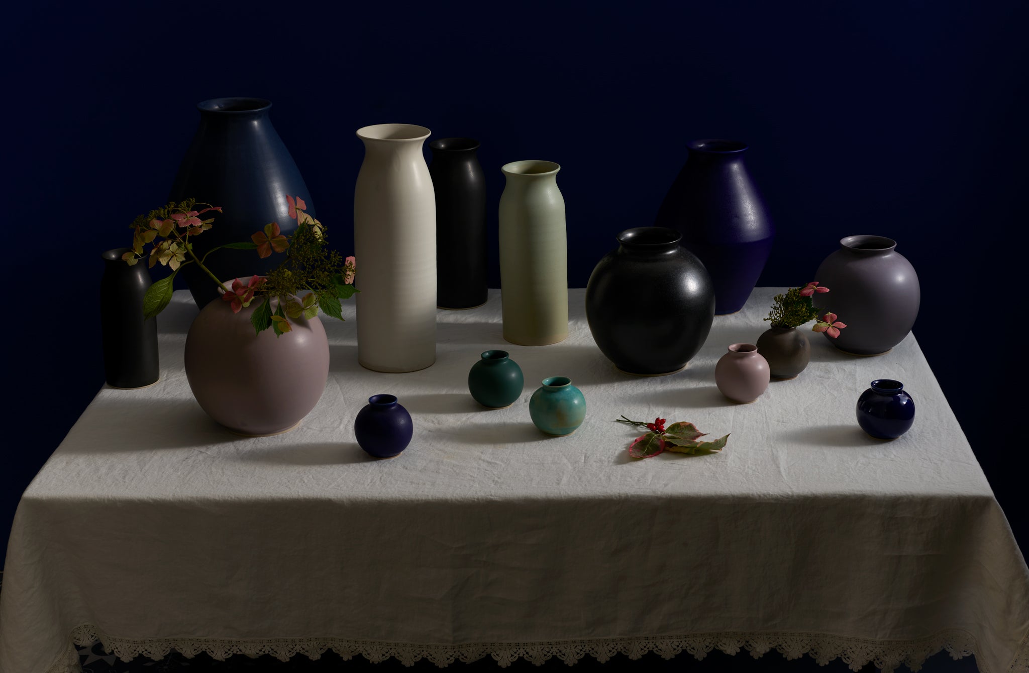 Mixture of Christiane Perrochon vases set on off white Sicily table cloth
