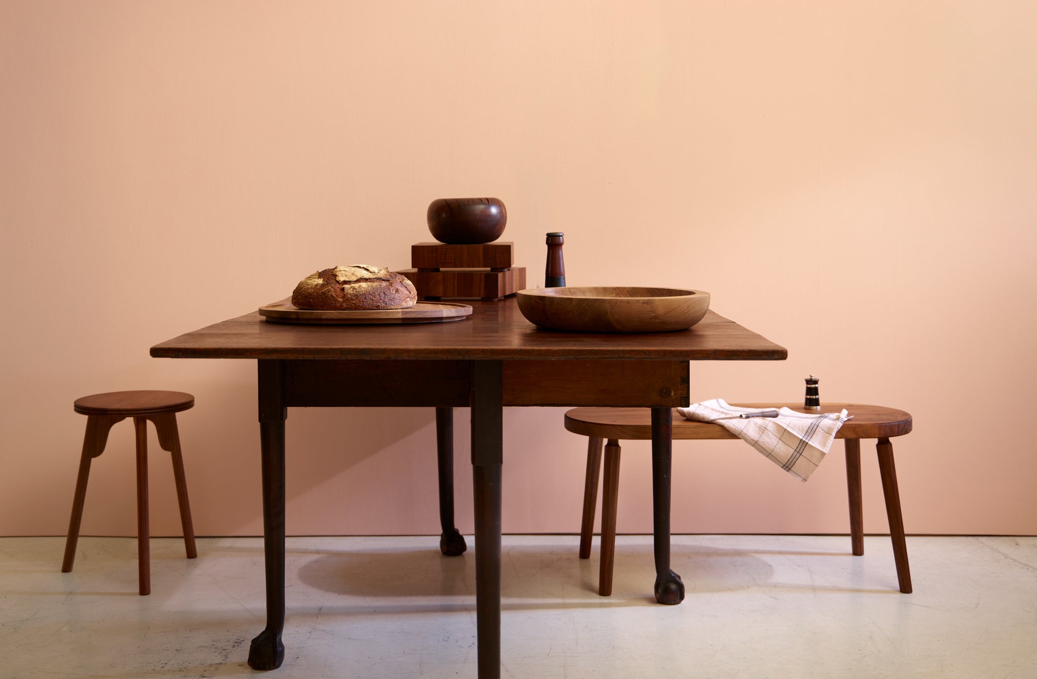 Antique 19th Century Mallorca Table set with Walnut Objects shown with an Ifuji walnut stool and Long Confidence walnut bench