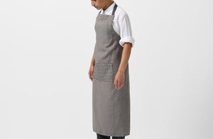 Model wearing MARCH Once Milano charcoal gingham apron.