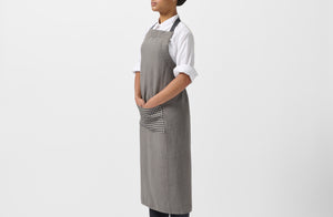 Model wearing MARCH Once Milano charcoal gingham apron.