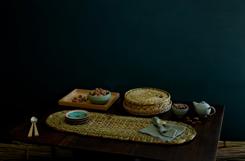 An antique table set to entertain with Christiane Perrochon and Victoria Morris ceramics nestled between Rush Matters runner and placemats.