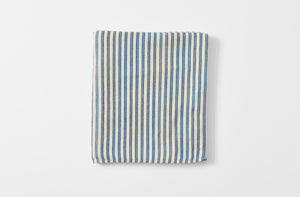 Blue and cream ticking stripe tablecloth folded.