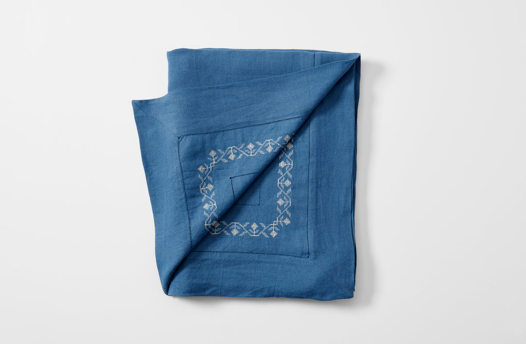 Embroidered blue ottoman vase tablecloth folded with embroidery detail