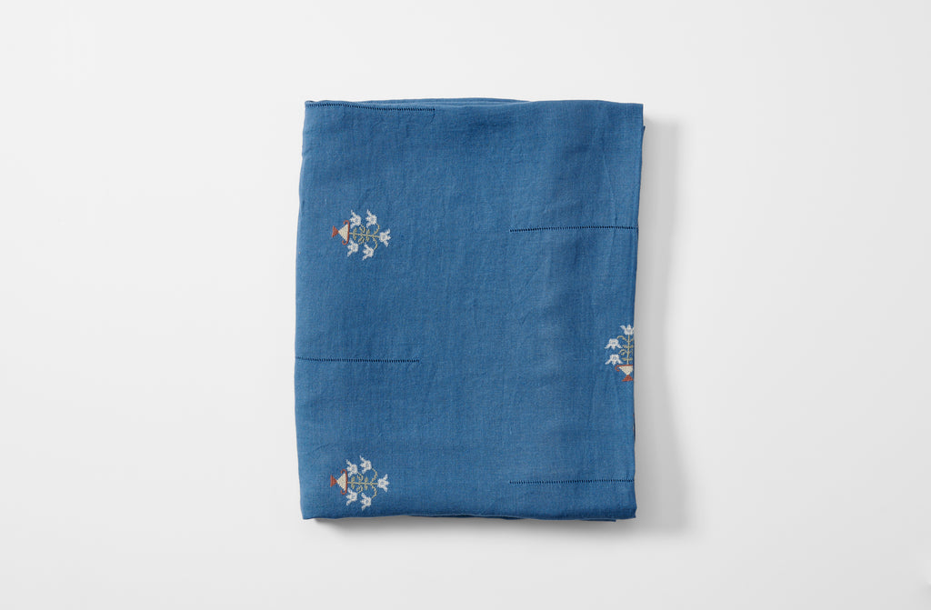 Embroidered blue ottoman vase tablecloth folded with additional embroidery detail