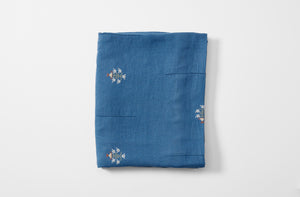 Embroidered blue ottoman vase tablecloth folded with additional embroidery detail 