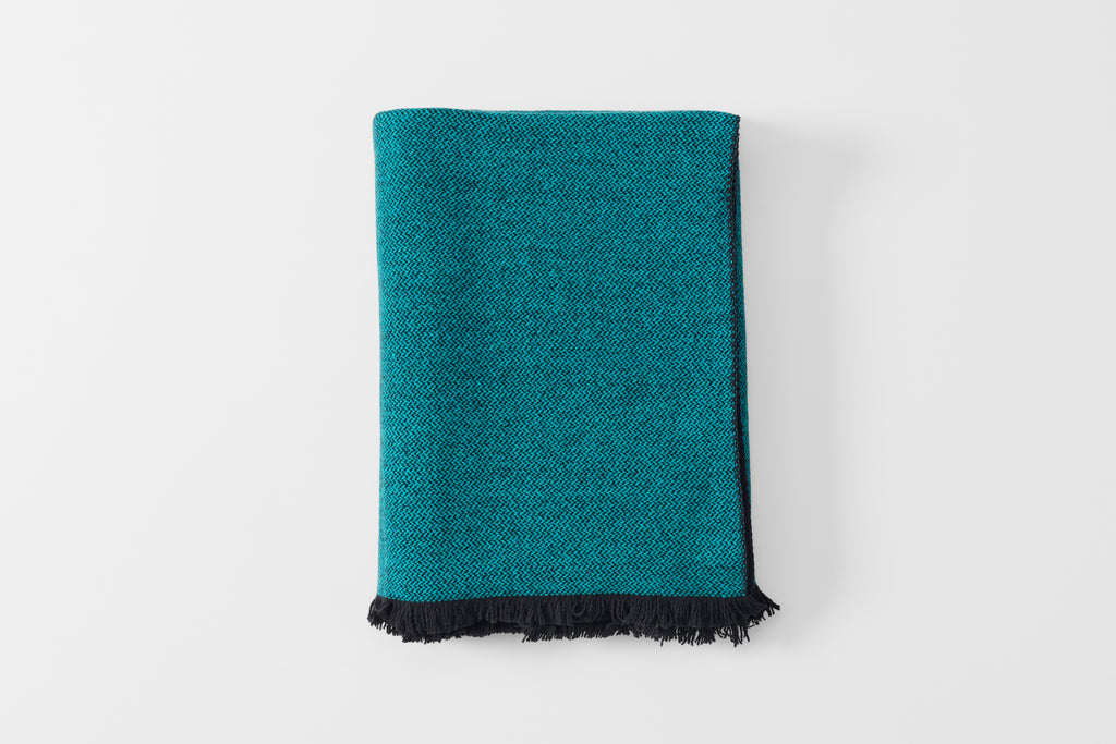 Folded blue scale cashmere throw blanket.