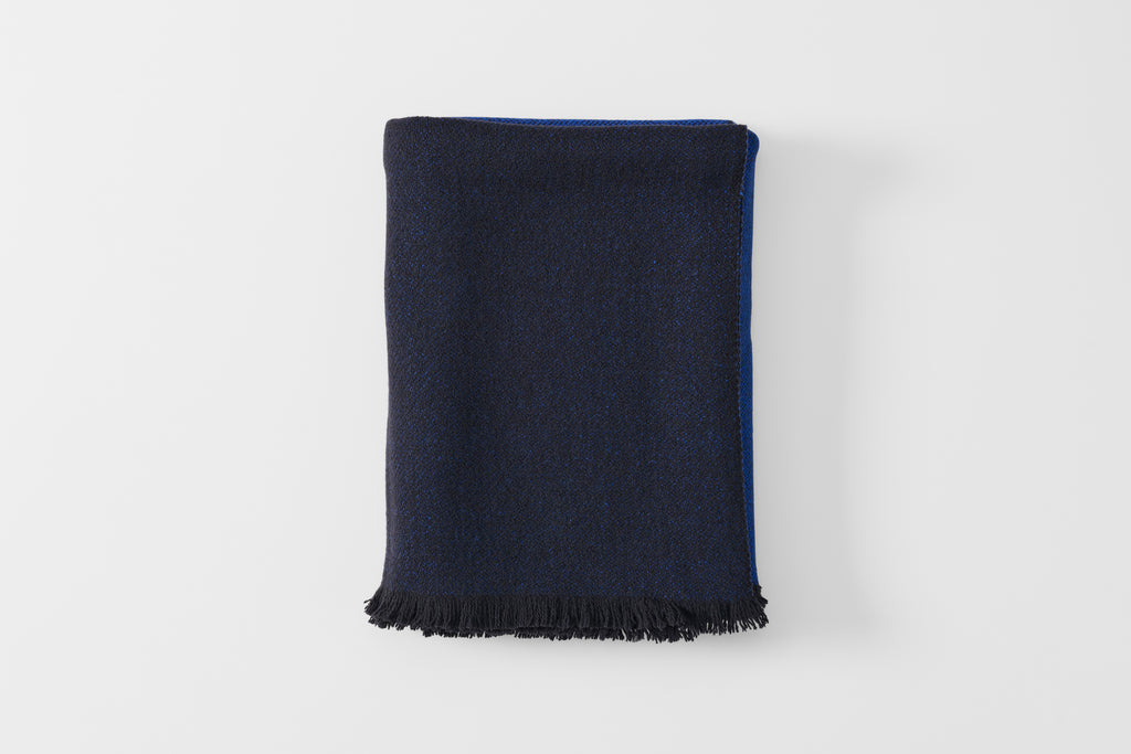 Folded blue scale cashmere throw blanket.