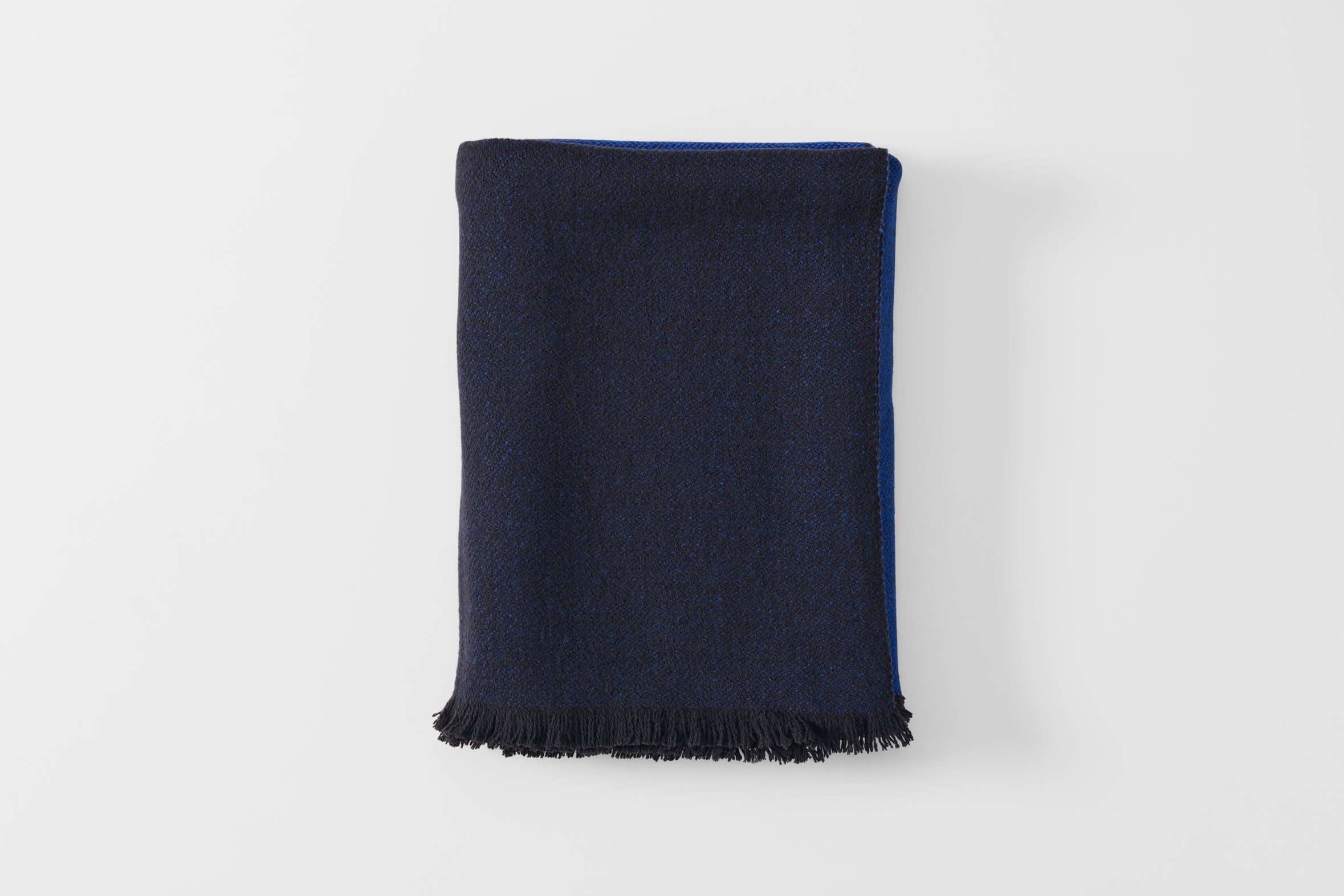 Folded blue scale cashmere throw blanket.