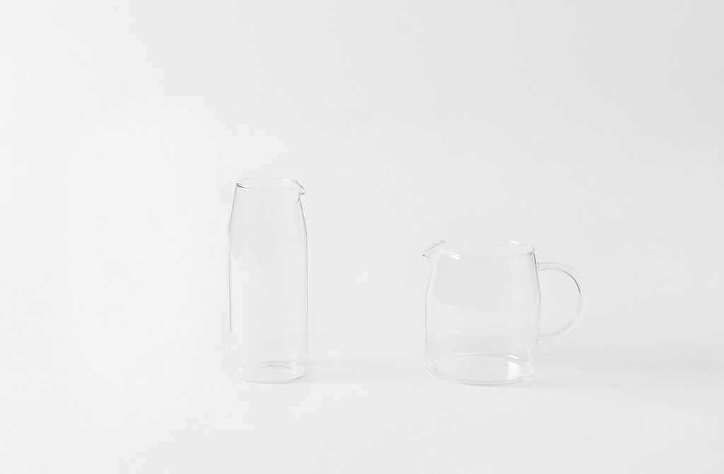 Clear glass pitcher and carafe on a white background. Default