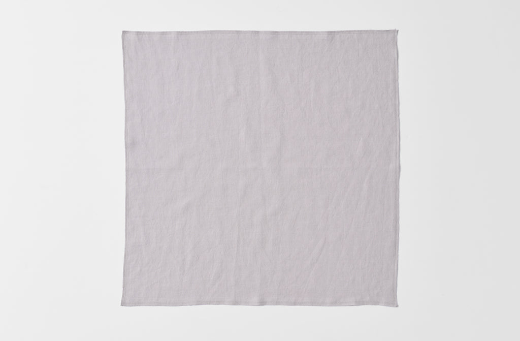 Detail of open boxwood silver linen overlock napkin.