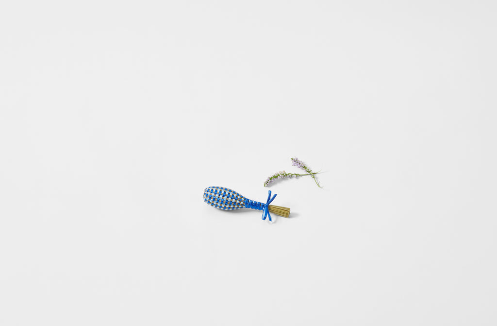 Petite lavender wand in bright blue next to lavender sprigs
