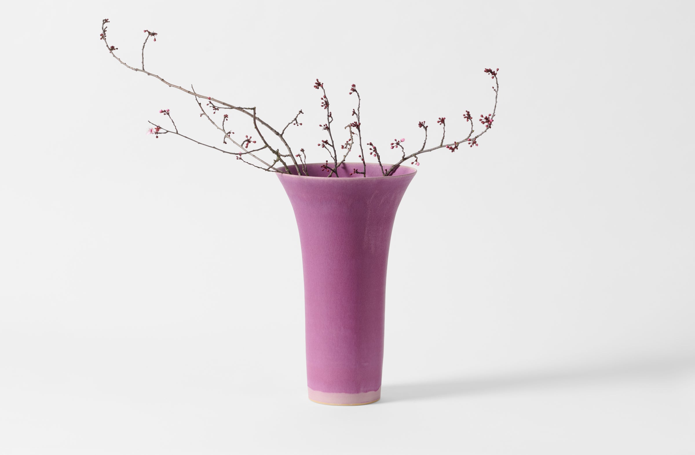 Extra small Christiane Perrochon flared fuchsia vase with cherry blossoms.