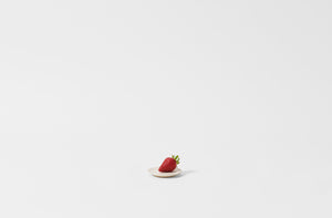 Christiane Perrochon powder white beige tiny plate with single strawberry.