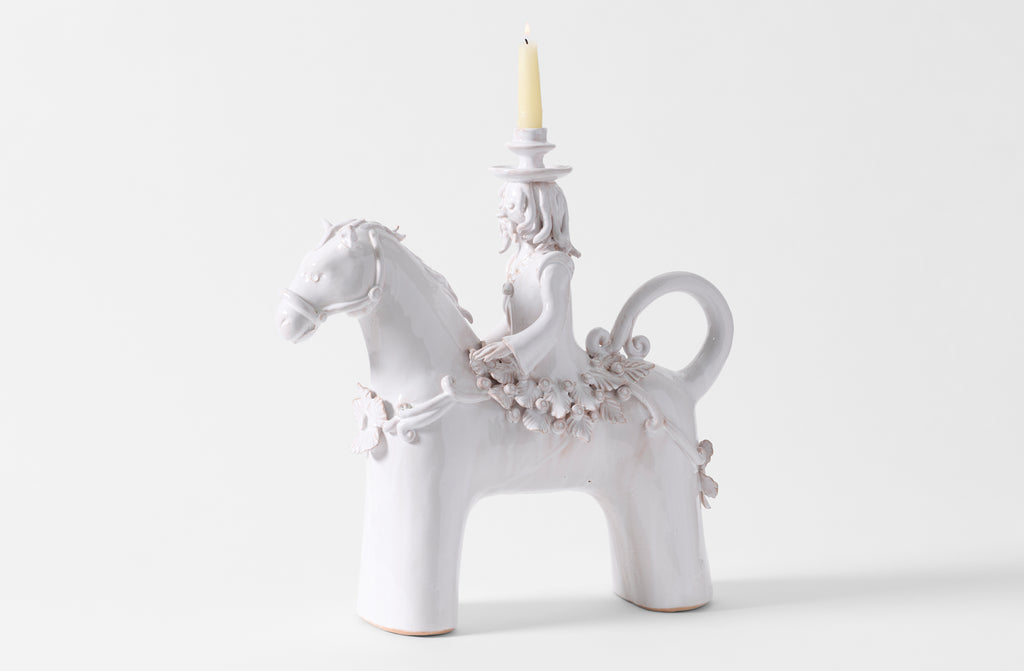 One Equestre large ceramic candle holder with candle.