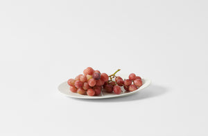 Hering Berlin white evolution oval dish holding grapes.