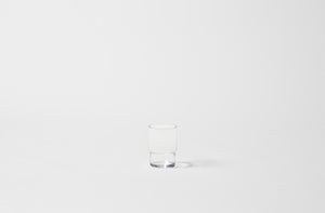 Single glass stacking tumbler on white background