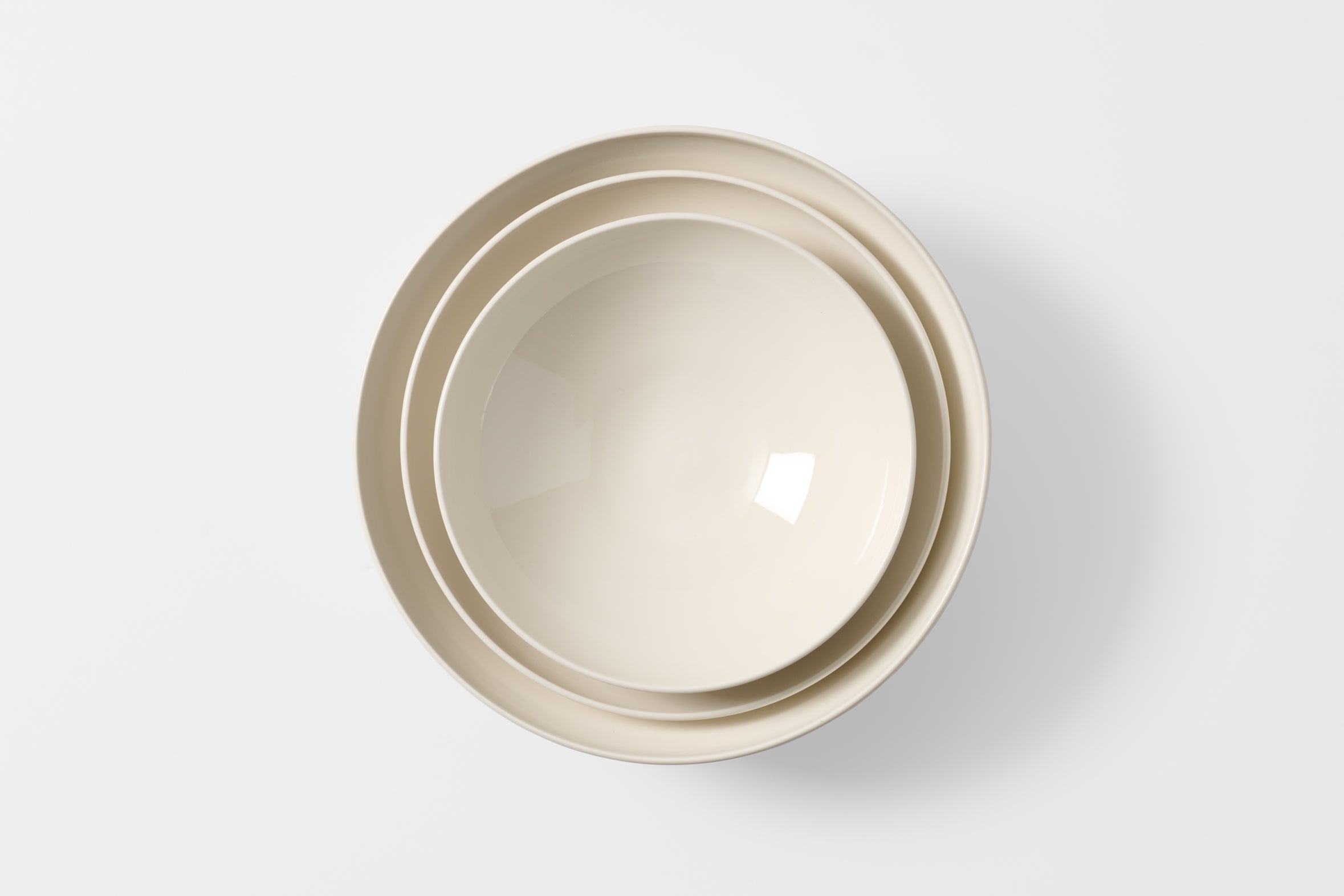 John Julian porcelain serving bowls nested overhead. Default