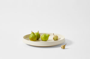 Kelly Wearstler alabaster dune low serving platter holding pears and quince.