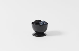 La Mere Ebony footed bowl holding berries