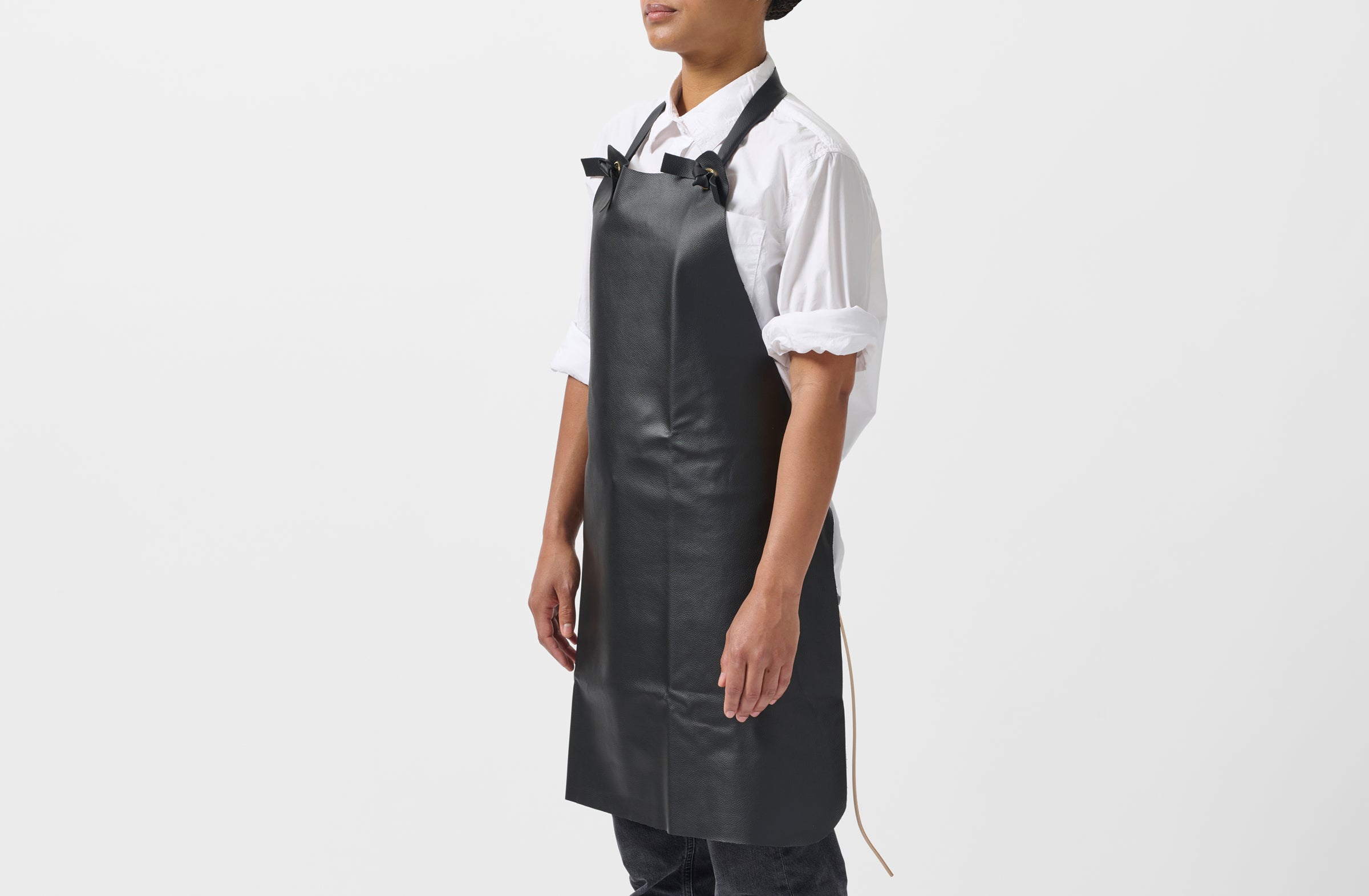 Model wearing Malle W. Trousseau black leather apron.