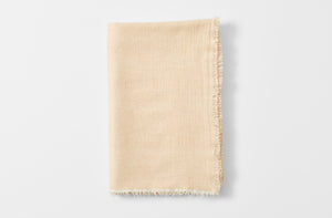 Straw and cream cashmere throw folded.