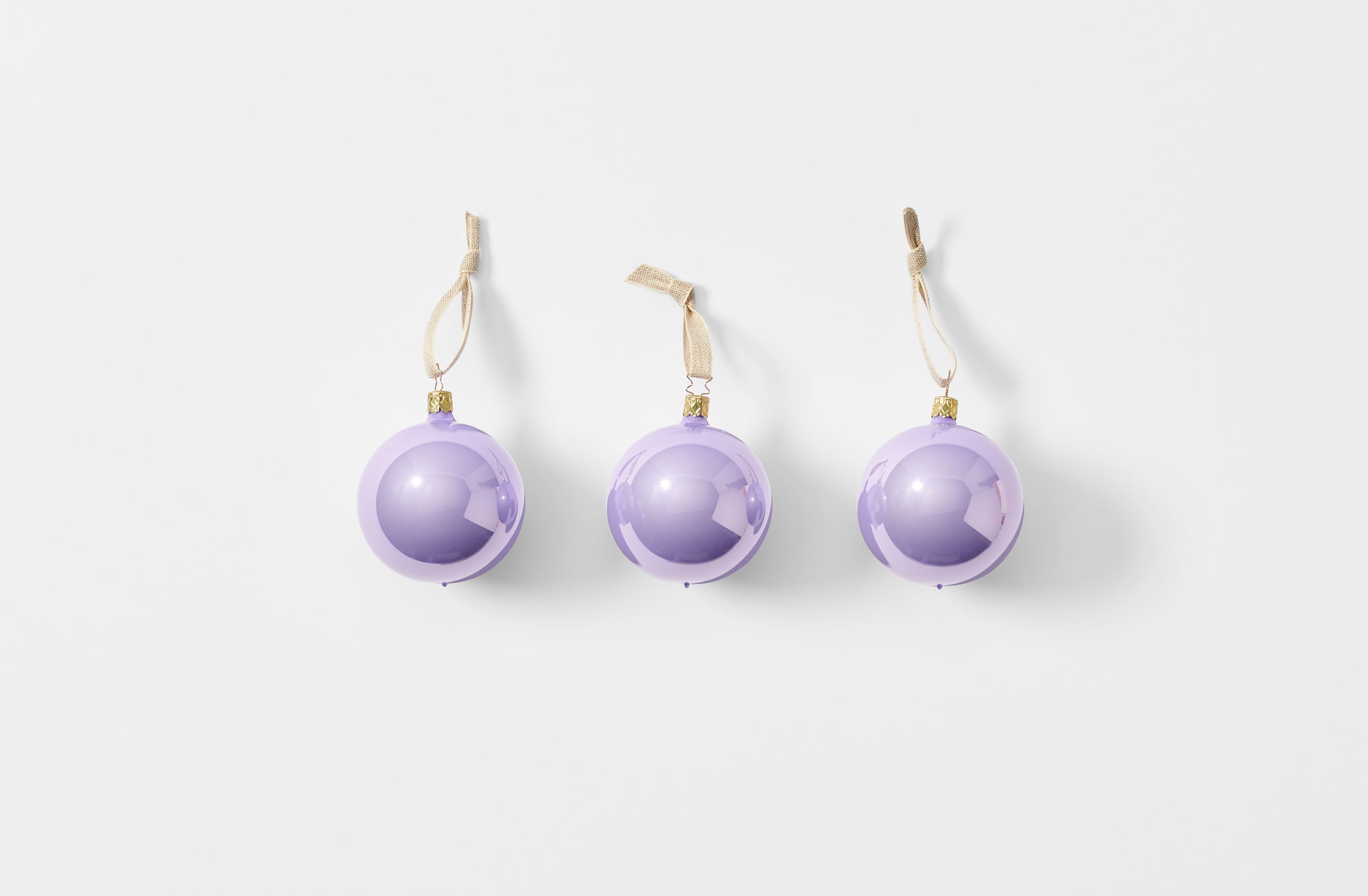 Set of three thistle glass ball ornaments strung with linen tape
