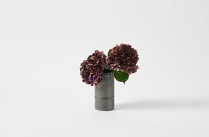 Tracie Hervy graphite cylinder vase holding hydrangeas 