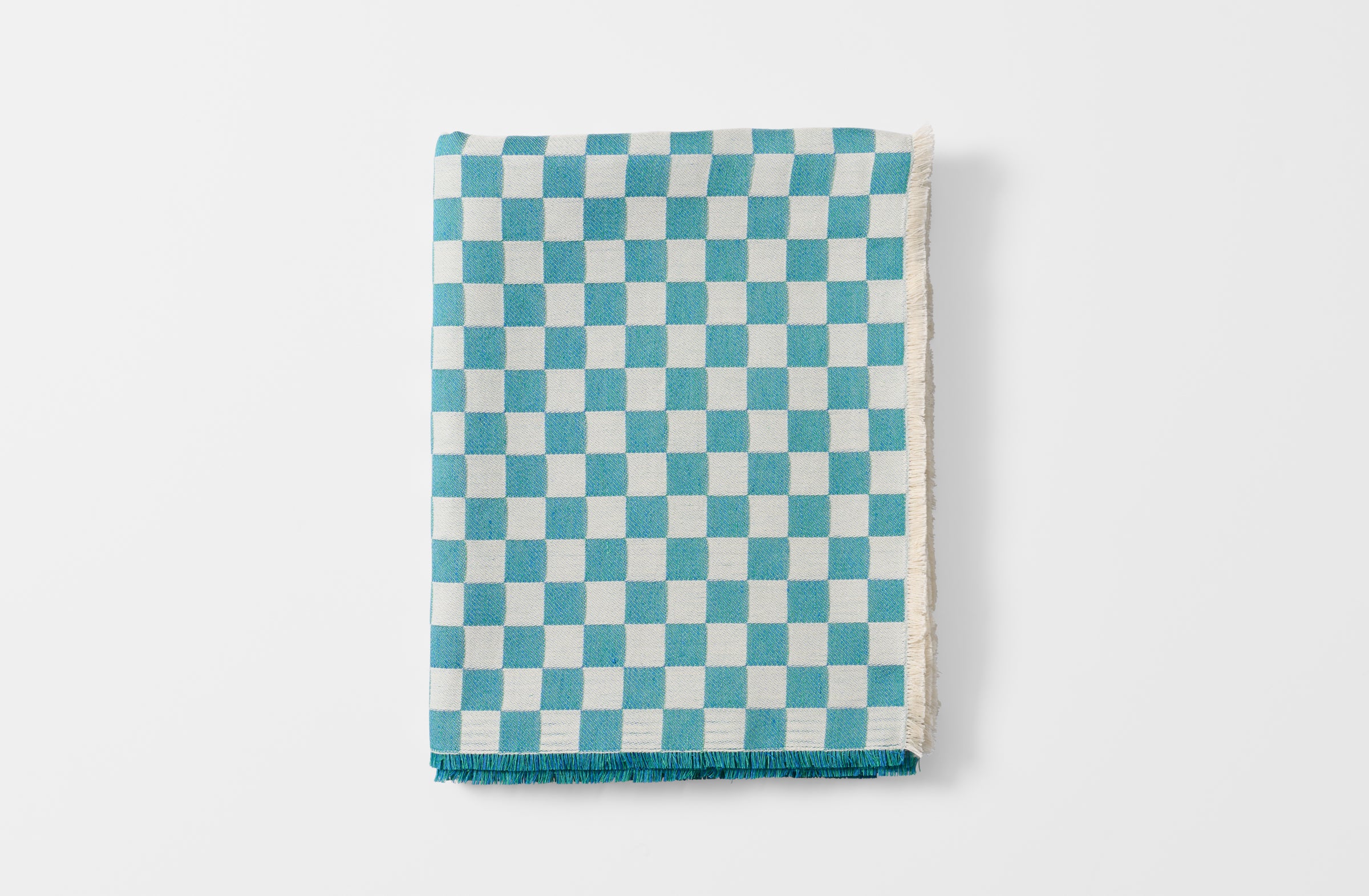 Folded turquoise check tablecloth.
