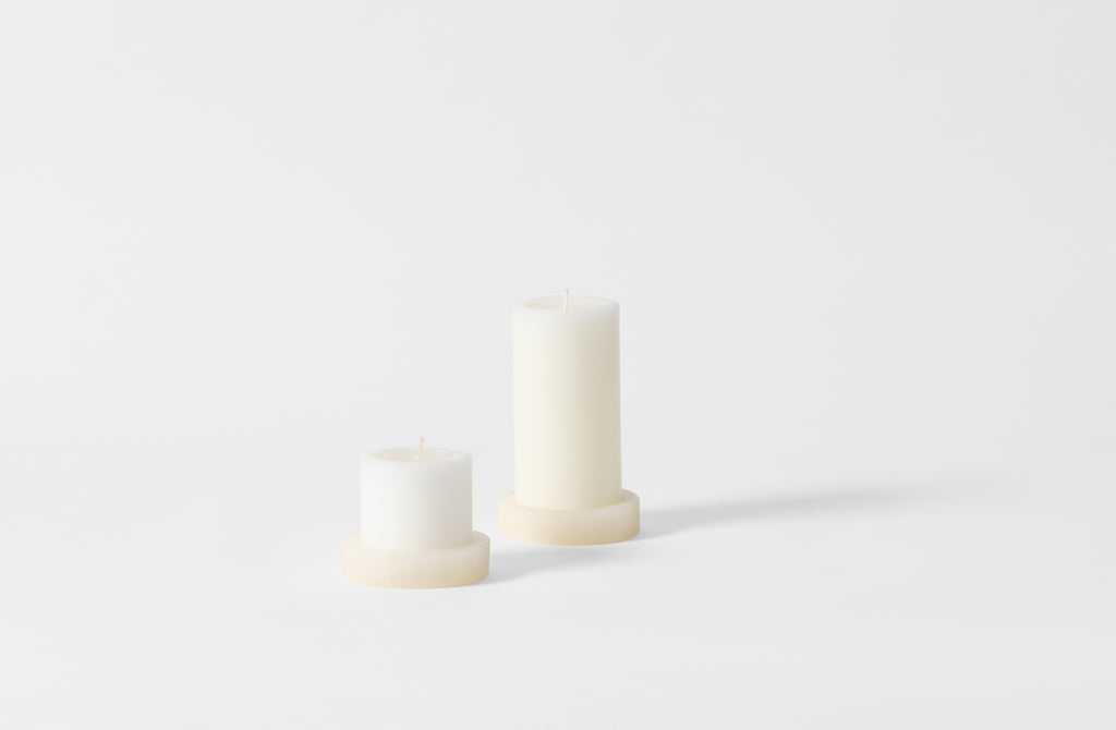 White onyx pillar candle holders with pillar candles.