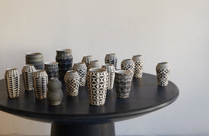At-MARCH-Dana-berchert-vases-enmasse-atop-faye-toogood-roly-poly-dining-table-in-charcoal
