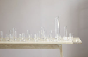 Collection of Deborah Ehrlich glassware on console table.
