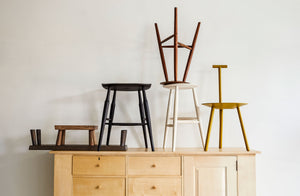 At-MARCH-stools-and-chairs-stacked-atop-joshua-vogel-cabinet-including-Sawyer-made-hunter-stool