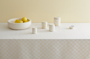 Michael-verheyden-sand-marble-bowl-and-canisters-with-cream-on-white-splatterware-canisters-on-cream-checked-tablecloth-by-Chiarastella Cattana-Default
