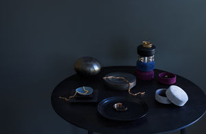 Michael-verheyden-multi-colored-pastille-suede-and-leather-round-containers-and-bronze-eclipse-bowl-with-jewelry-on-table-Default