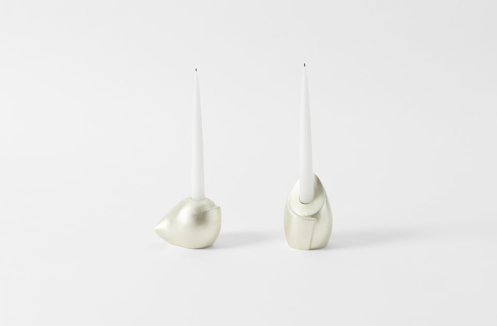 carol leskanic white gold short and tall sculptural candlesticks with white taper candles