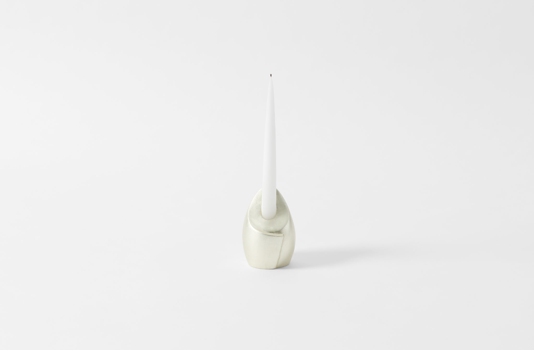 carol leskanic white gold tall sculptural candlestick with white taper candle