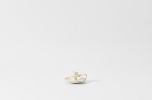 cream on white chamberstick candleholder