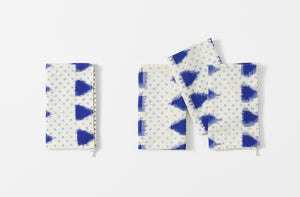 four folded gregory parkinson indigo triangle napkins