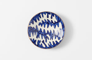 malaika hand painted ceramic matisse patterned pasta bowl in blue and white on brown shown from overhead
