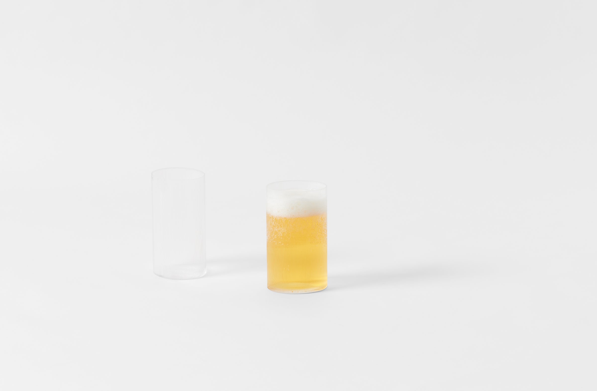 pair of glasses with one having beer