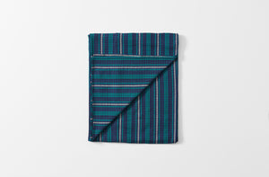 tensira navy and green tartan plaid tablecloth shown folded with one corner turned up