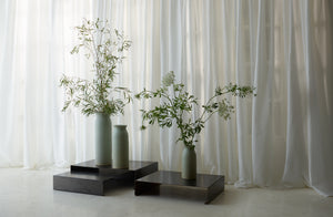 pale green christiane perrochon vases with sparce floral arrangement.-Default