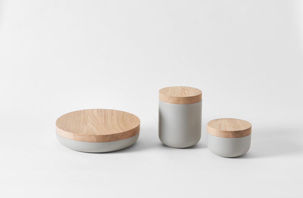 Three cylindrical containers with wooden lids on a white background. Default 
