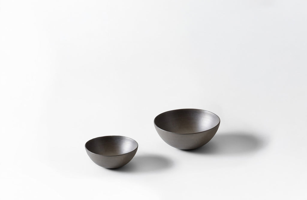 Two metallic bowls on a white background. Default