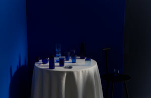 Blue R and D Lab Lobmeyr  Dibbern and David Fuin glassware arranged artfully on round tabletop.