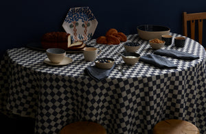 Brickett Davda navy and smoke tabletop with Peter Speliopoulos mid wash denim napkins