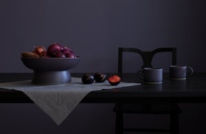 Christiane perrochon plum centerpiece with indigo mug with sawkille chair and fruit